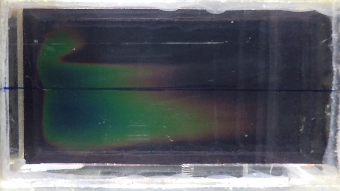 Colors developing on liquid crystal sheet in channel during an experiment